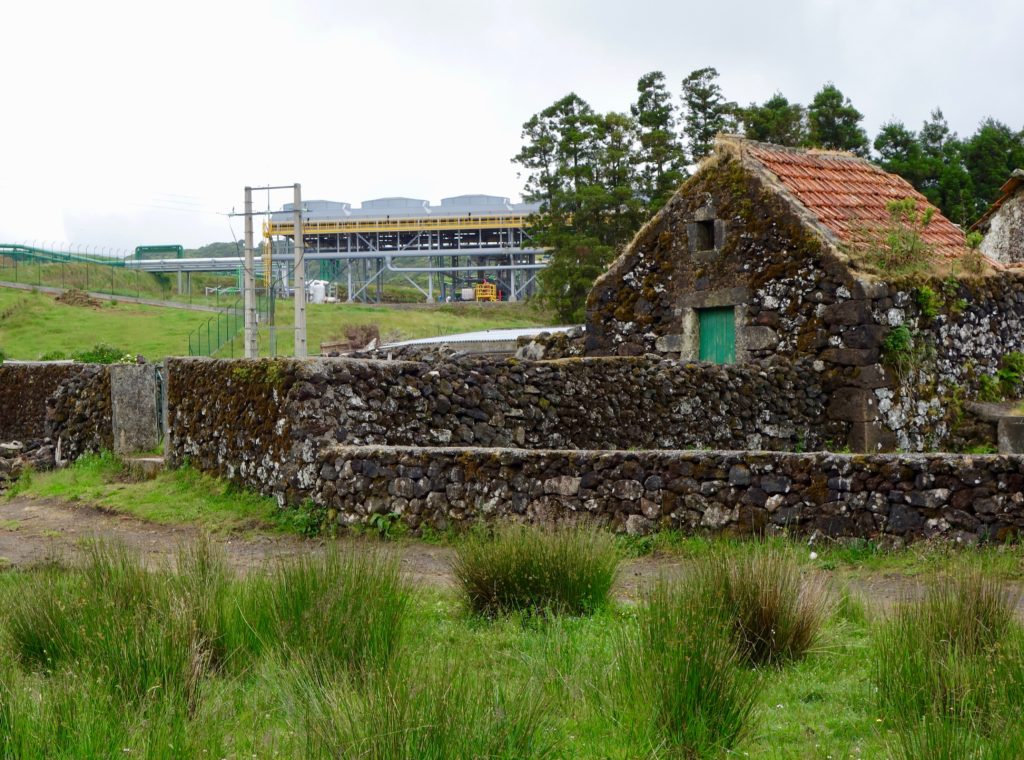 photo of Pico Alto Terceira geothermal plant next to antique farmer's barn on hiking trail.