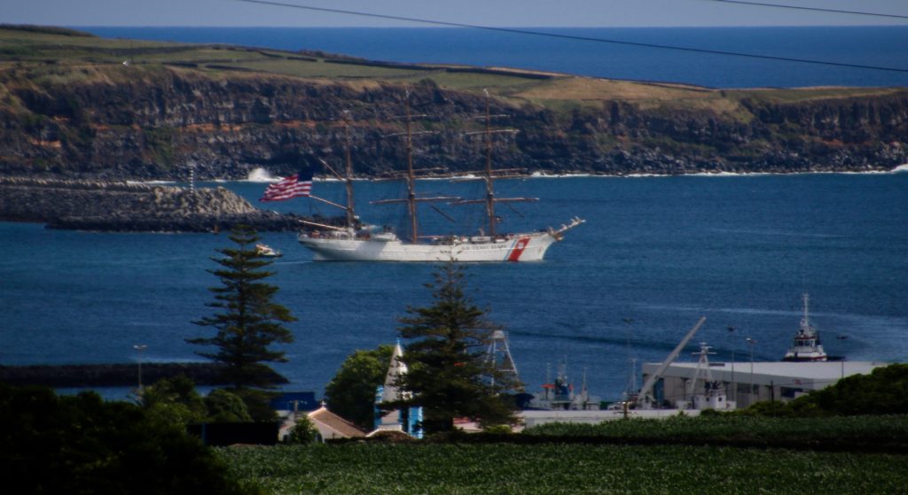 The USCGC Eagle sails out of Praia da Vitoria, still flying the beautiful flag. 