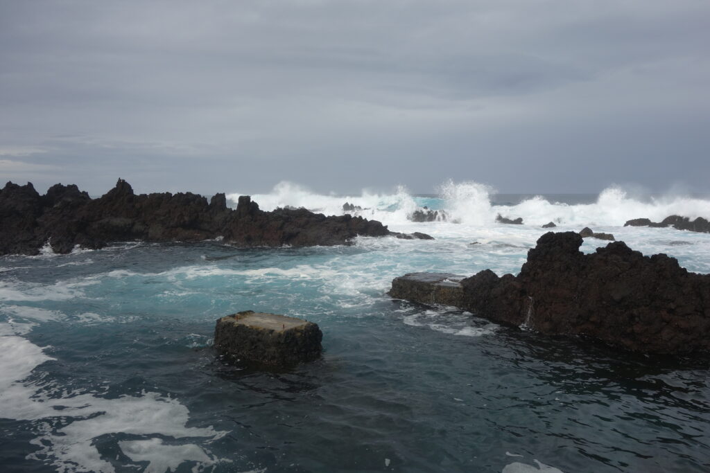 Waves crashing against the volcanic shoreline in the winter winds.